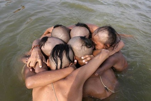 Pupils from Hindu religious school huddle as they take holy dip in Sangam
