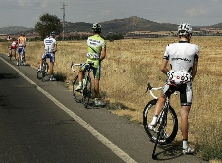 Riders urinate during the 17th stage of the Tour of Spain “La Vuelta” cycling race between Ciudad Real and Talavera de la Reina