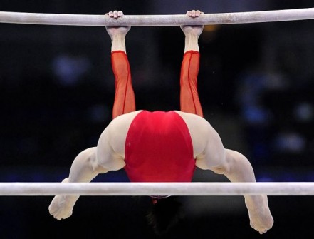Uemura of Japan competes on the uneven bars in the qualification round of the Gymnastics World Championships in London