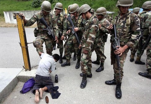 A soldier gets his boots shined as others look on in Nicaragua’s Las Manos border with Honduras