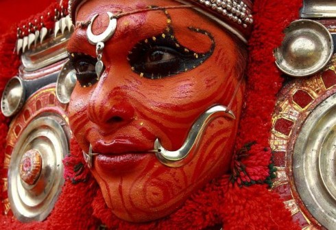 A dancer waits to perform during festivities in Kochi