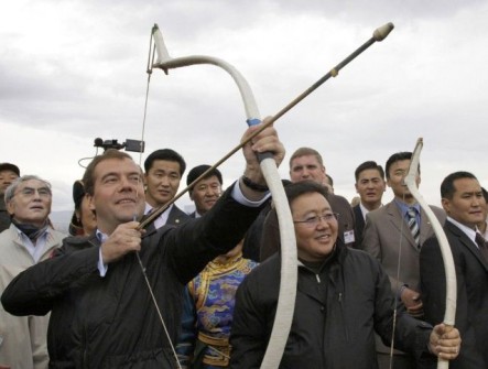 Russia’s President Dmitry Medvedev draws a bow as his Mongolian counterpart Tsakhiagiin Elbegdorj looks on during celebrations for Mongolian festival Naadam in Ulan Bator