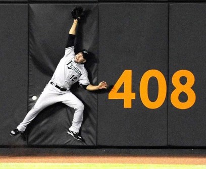 Florida Marlins outfielder Cody Ross fails to catch a triple by New York Mets batter David Wright in New York