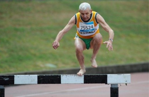 Competitors make the water jump during the Mens steeplechase for 70+ year olds during the World Masters Games