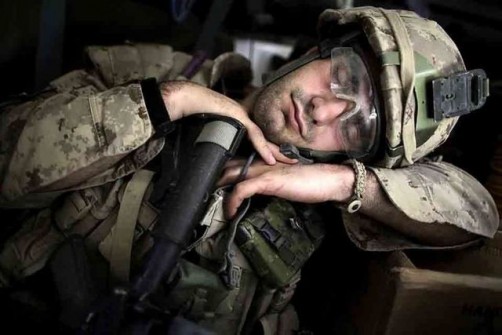 A Canadian soldier takes a nap after taking part in a search operation for improvised explosive devices in Kandahar