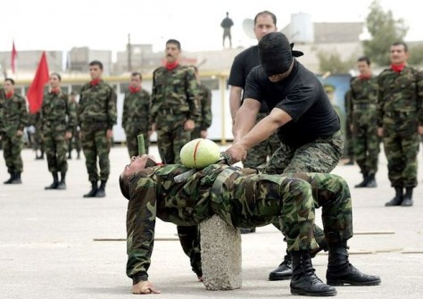 A blindfolded Kurdish security officer demonstrates his skills during his graduation ceremony in the city of Arbil