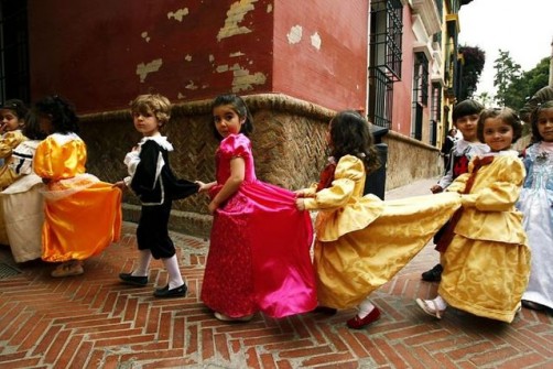 School children wearing costumes line up as they walk to visit a permanent exhibition at Velazquez research centre in Seville